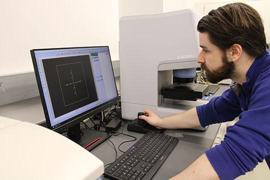 man with beard, looking at computer